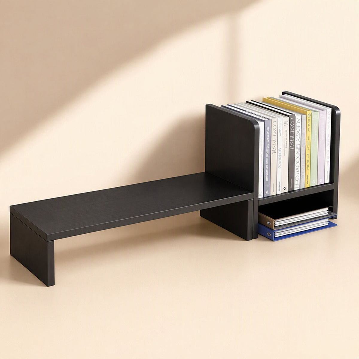 Shelfraise – Black riser extended to the left of a bookend-style shelf holding upright books and folders