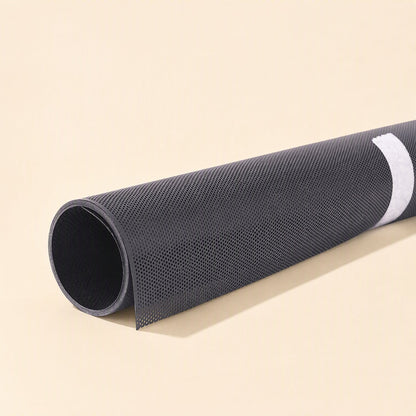Netshield – Close-up of a rolled black perforated mesh sheet with a white adhesive strip along its edge