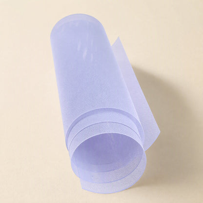 Netshield – Translucent pale lavender mesh sheet curled into a loose roll against a cream backdrop