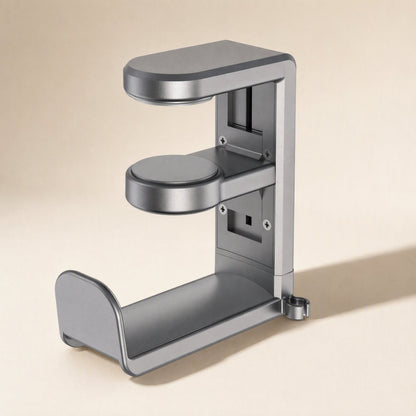 Spinrest Headphone Stand in gray metal, front three-quarter view showing the clamp arms and screw plates