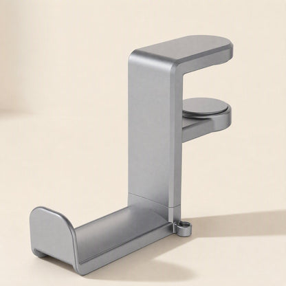 Spinrest – Gray rotating desk clip headphone stand seen from the side, with round clamp pad and cable loop at the base