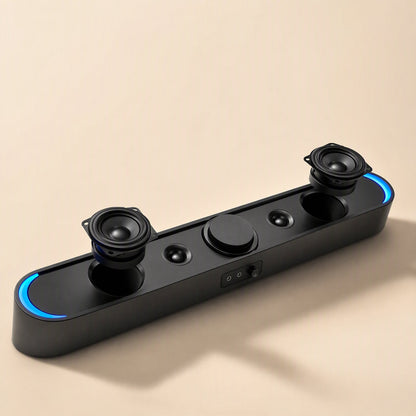 Desksonic – Soundbar with grille removed, showing two woofers, two small tweeters, a center knob and blue end lights