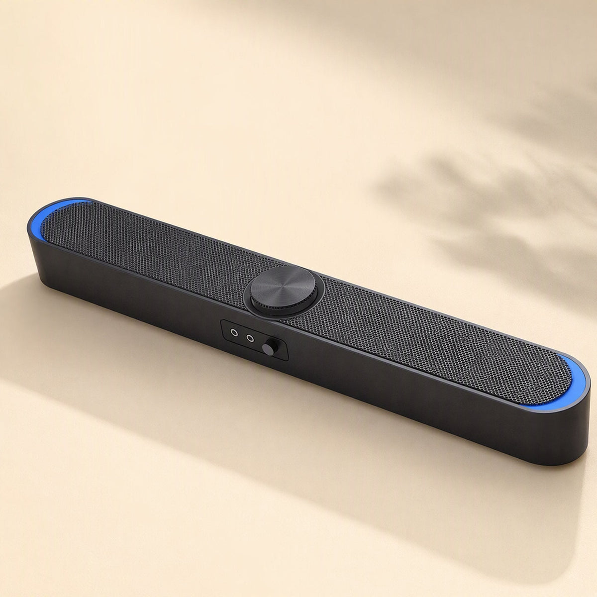 Desksonic – Black bar speaker with blue light ends, front controls and a shadow of leaves on a cream backdrop