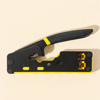 Cablepress – Side view of the pliers lying flat, with the handle raised and two yellow-lined crimping slots at the right end