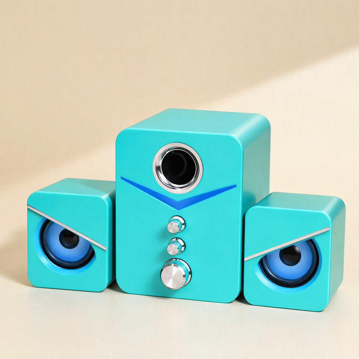 Soundbud – Teal 2.1-channel speaker trio with chrome knobs and blue glowing eye-style satellites, front view
