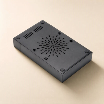 Diskbox – Underside of the black enclosure showing circular ventilation slots, vent grilles and four rubber feet