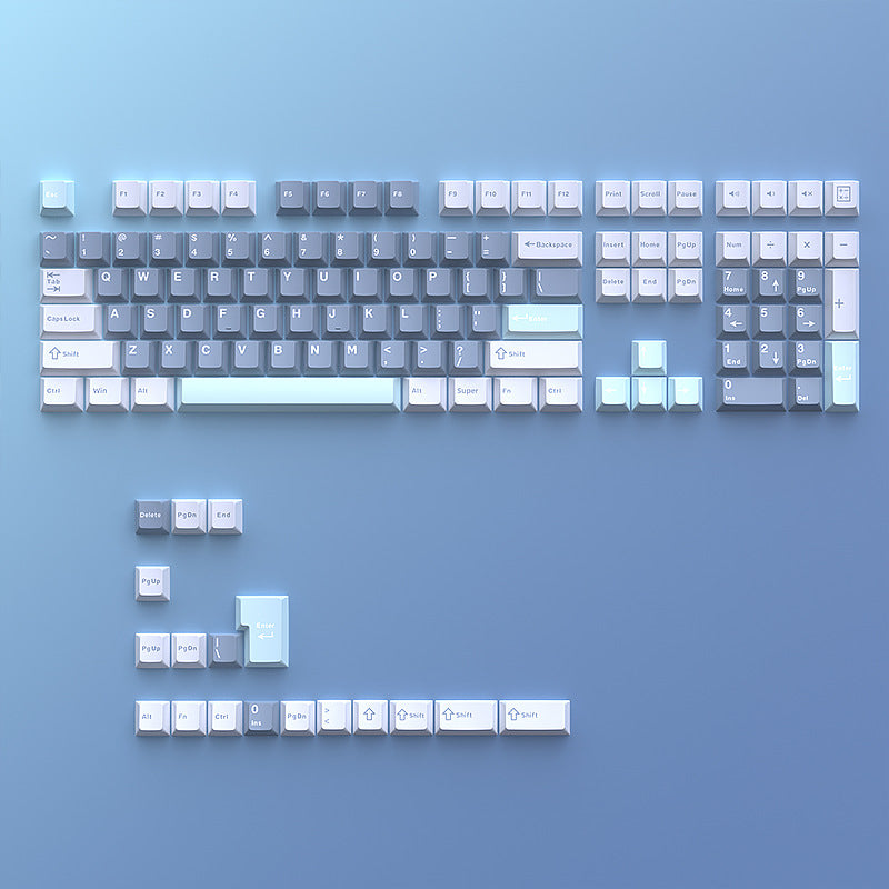 Cloudira – Full keycap set laid flat on a blue background, showing alphanumeric, function and arrow keys with extras below