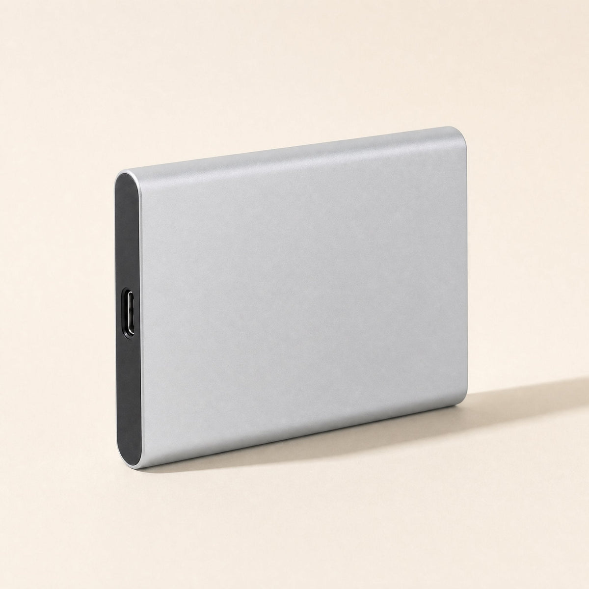Shellswift – Silver metal portable drive standing on its long edge, with the USB-C port on the dark end panel