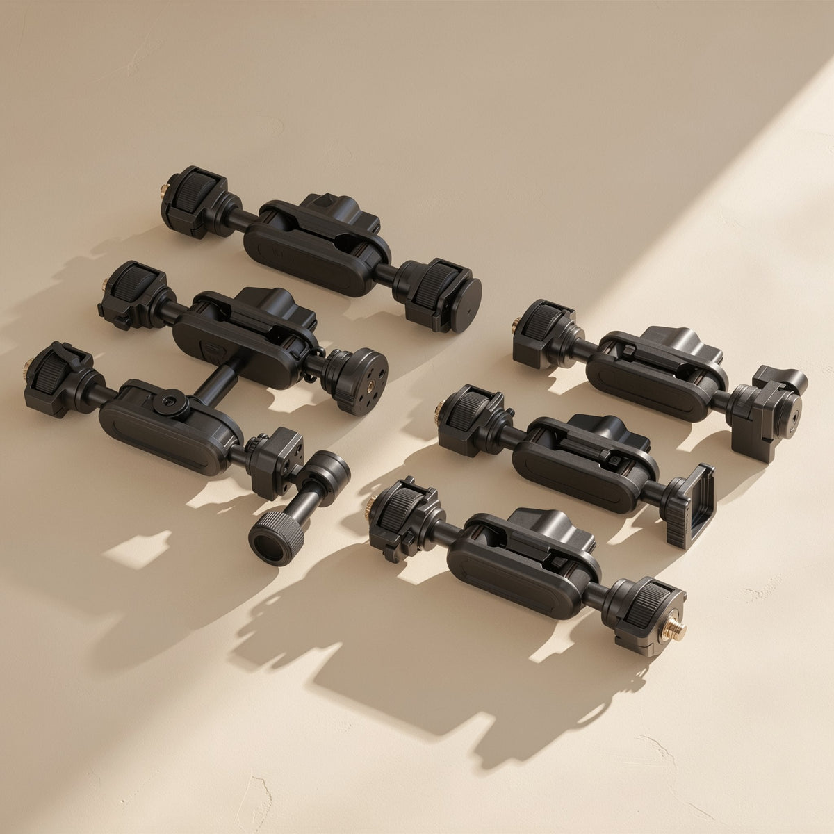 Armanchor Alloy Magic Arm Phone Mount in black, six arm assemblies laid out on a beige surface