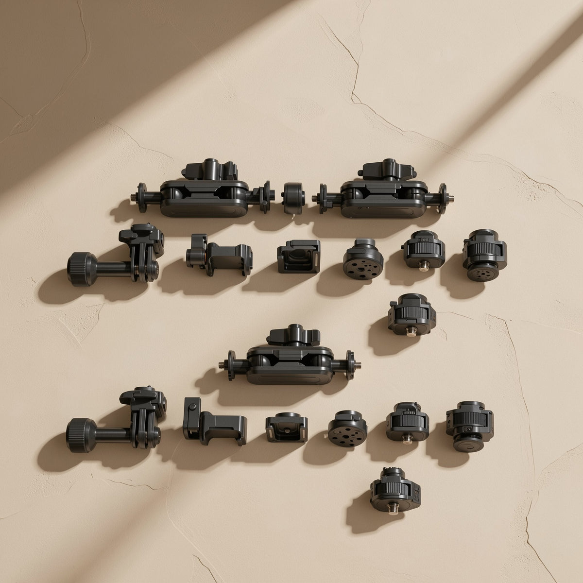 Armanchor – Disassembled black magic arm parts, ball-joint arms, clamps and screw adapters, arranged in rows