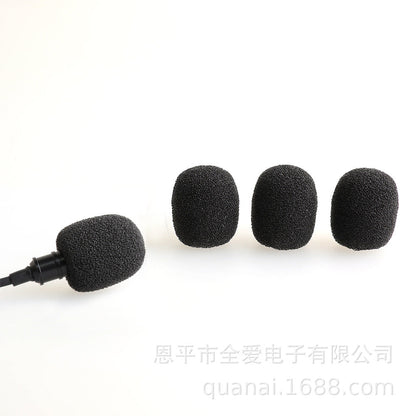 Windsponge – Black foam mic cover fitted on a lavalier microphone beside three loose covers on white