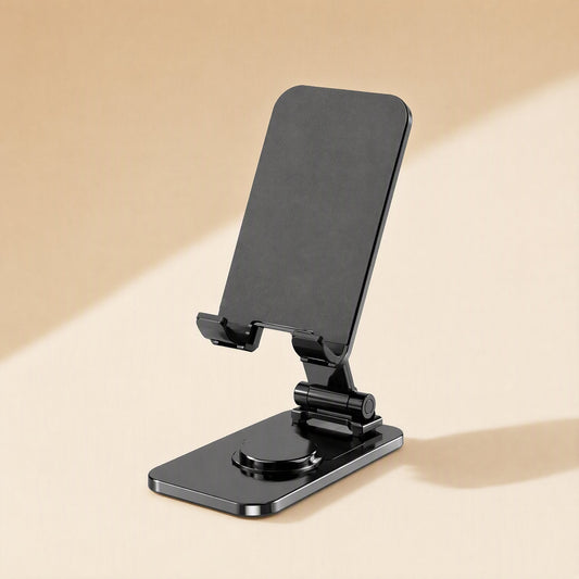 Spinprop – Black foldable phone stand with a rotating round base, shown at an angle on a beige backdrop
