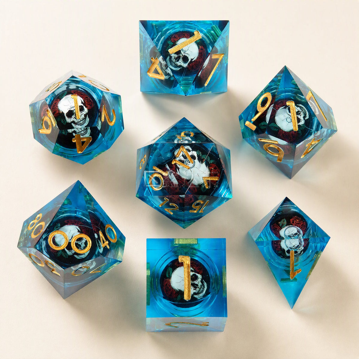 Fateforge Twenty-Sided Resin Dice: blue set with gold numbers and skulls in red roses, top-down on cream