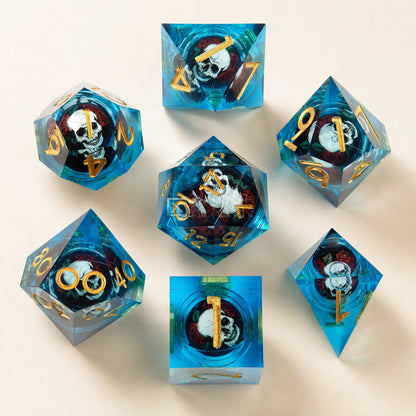 Fateforge Twenty-Sided Resin Dice: blue set with gold numbers and skulls in red roses, top-down on cream