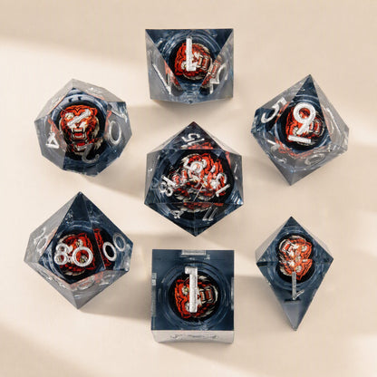 Fateforge – Grey resin dice with silver numerals and a red-orange tiger face inside each die, laid out on a cream surface