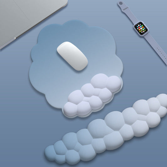 Wristnest – Cloud-shaped blue-gray mouse pad and matching wrist rests next to a white mouse and smartwatch