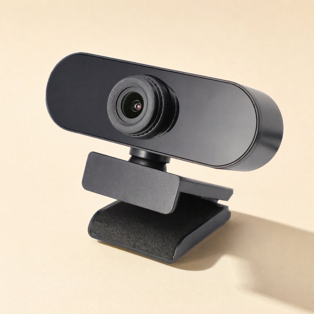 Talkview USB Camera – black webcam on a padded clip stand, angled three-quarter view, with a soft shadow on a cream surface