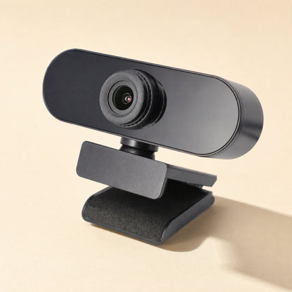 Talkview USB Camera – black webcam on a padded clip stand, angled three-quarter view, with a soft shadow on a cream surface