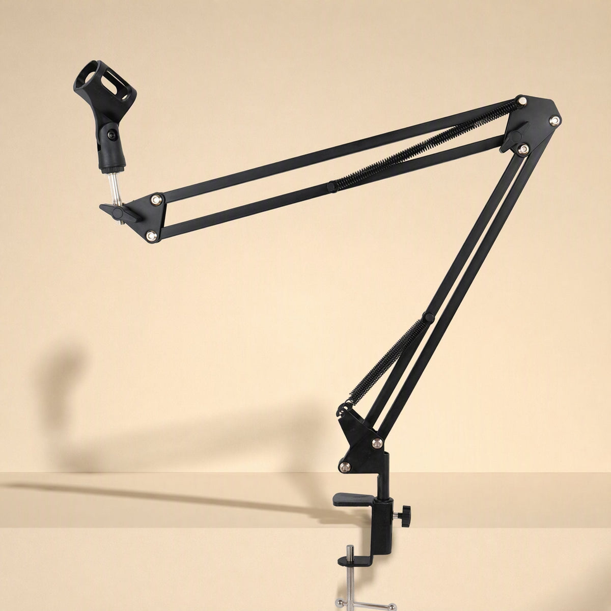 Voicebrace Alloy Desktop Microphone Bracket with extended black arm and mic clip, clamped to a desk edge