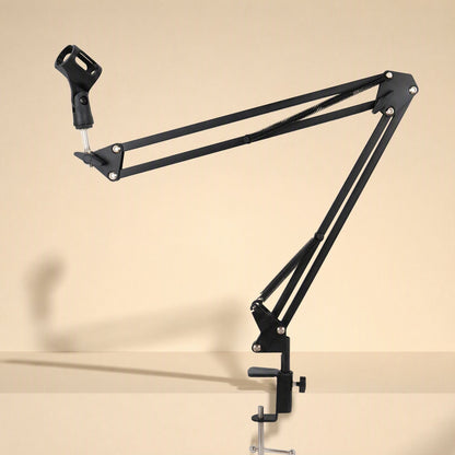 Voicebrace Alloy Desktop Microphone Bracket with extended black arm and mic clip, clamped to a desk edge