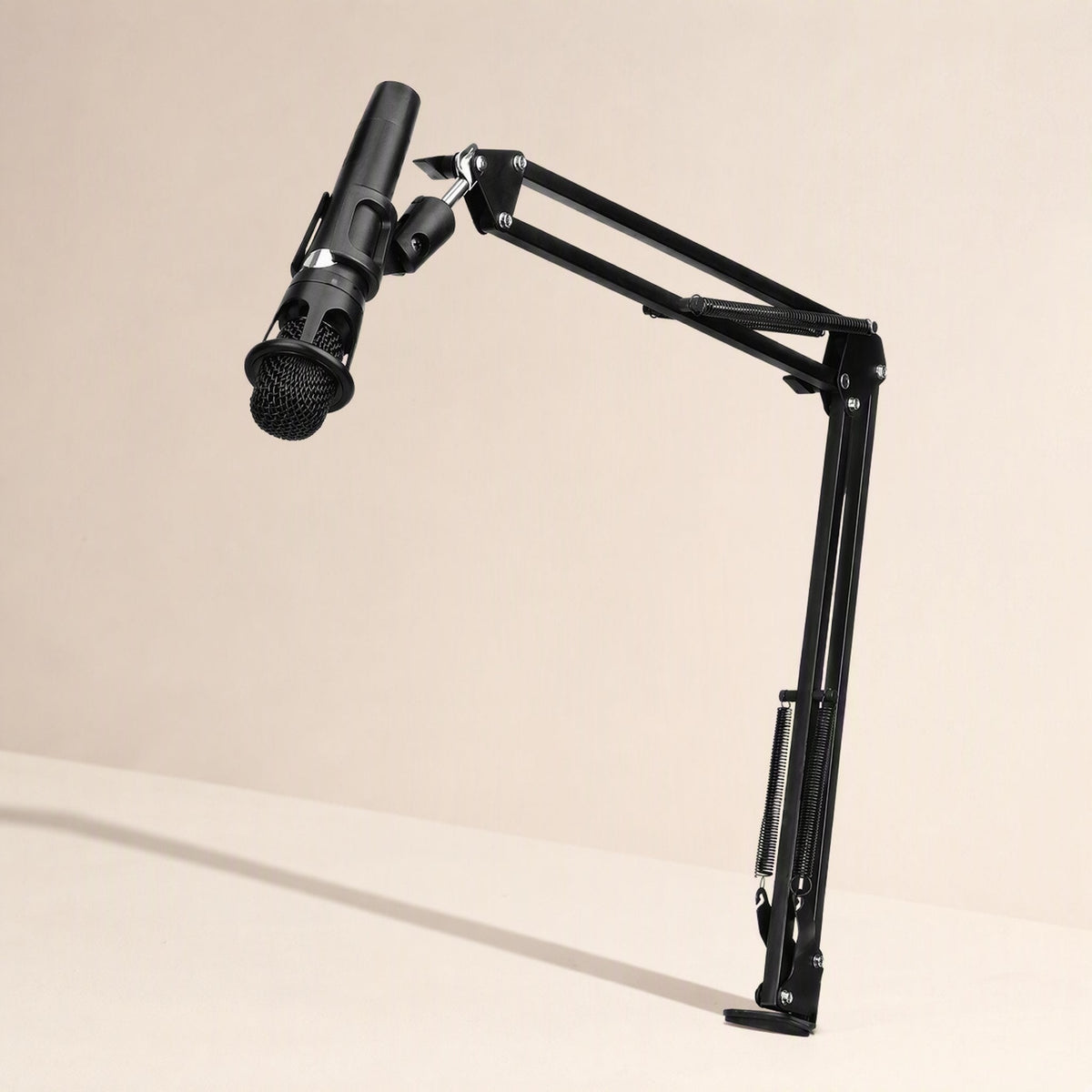 Voicebrace – Black suspension arm holding a microphone above a desk, side view of the springs and clamp