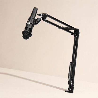 Voicebrace – Black suspension arm holding a microphone above a desk, side view of the springs and clamp