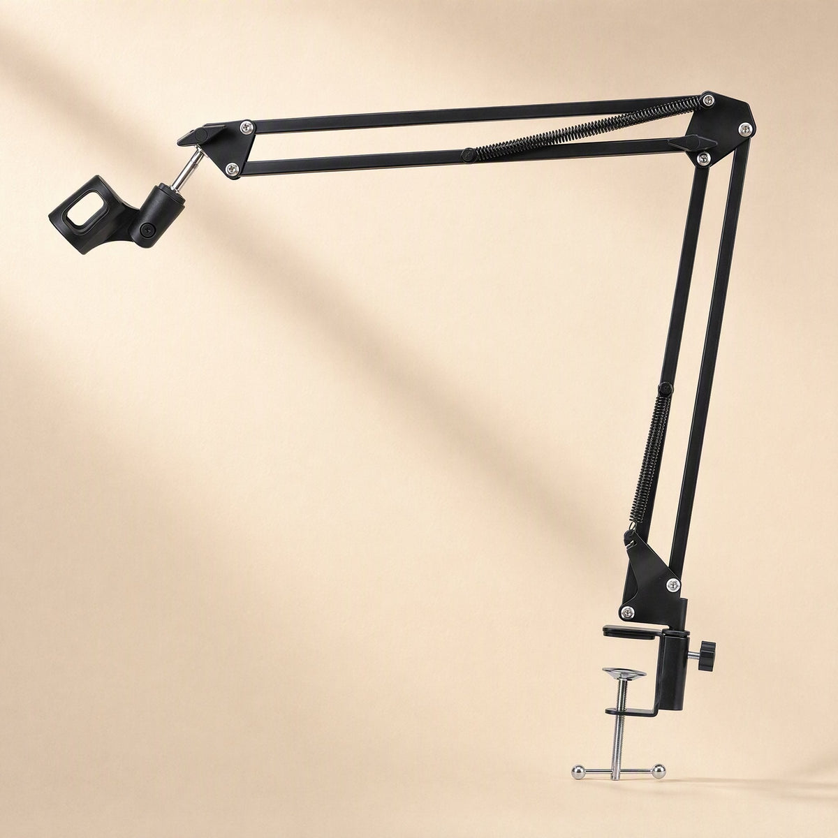 Voicebrace – Extended black boom arm with empty microphone clip and screw clamp, shown against a soft beige backdrop
