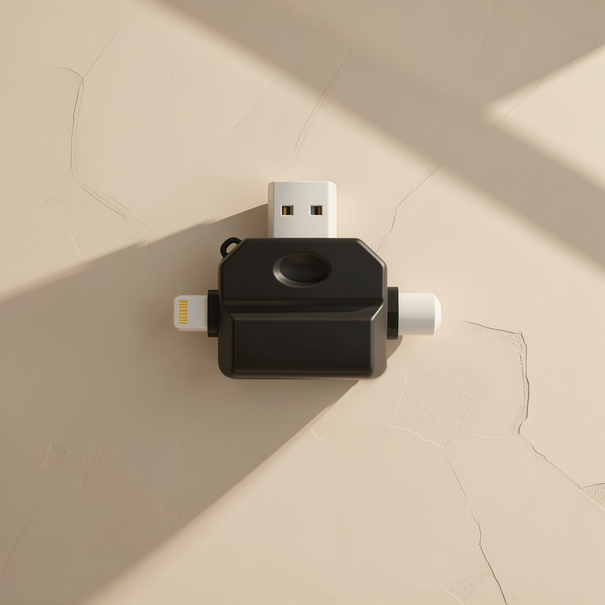 Typeport – Black multi-port card reader seen from above with USB-A and Lightning plugs on a cream wall surface