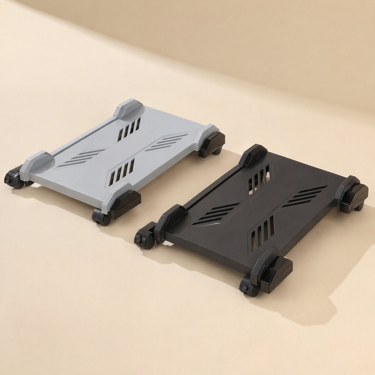 Deskroll – Grey and black wheeled computer stands side by side, showing slanted ventilation slots on each top