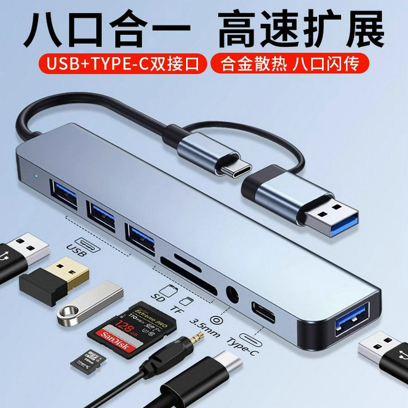 Voltcast – Gray aluminum hub with USB ports, SD/TF slots, 3.5mm jack and Type-C port beside flash drives and cards