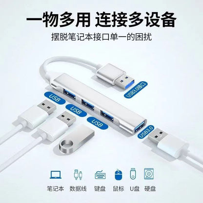 Alloyhub – White four-port hub with USB-A plug, three USB ports and one USB 3.0 port, with cables and flash drive nearby