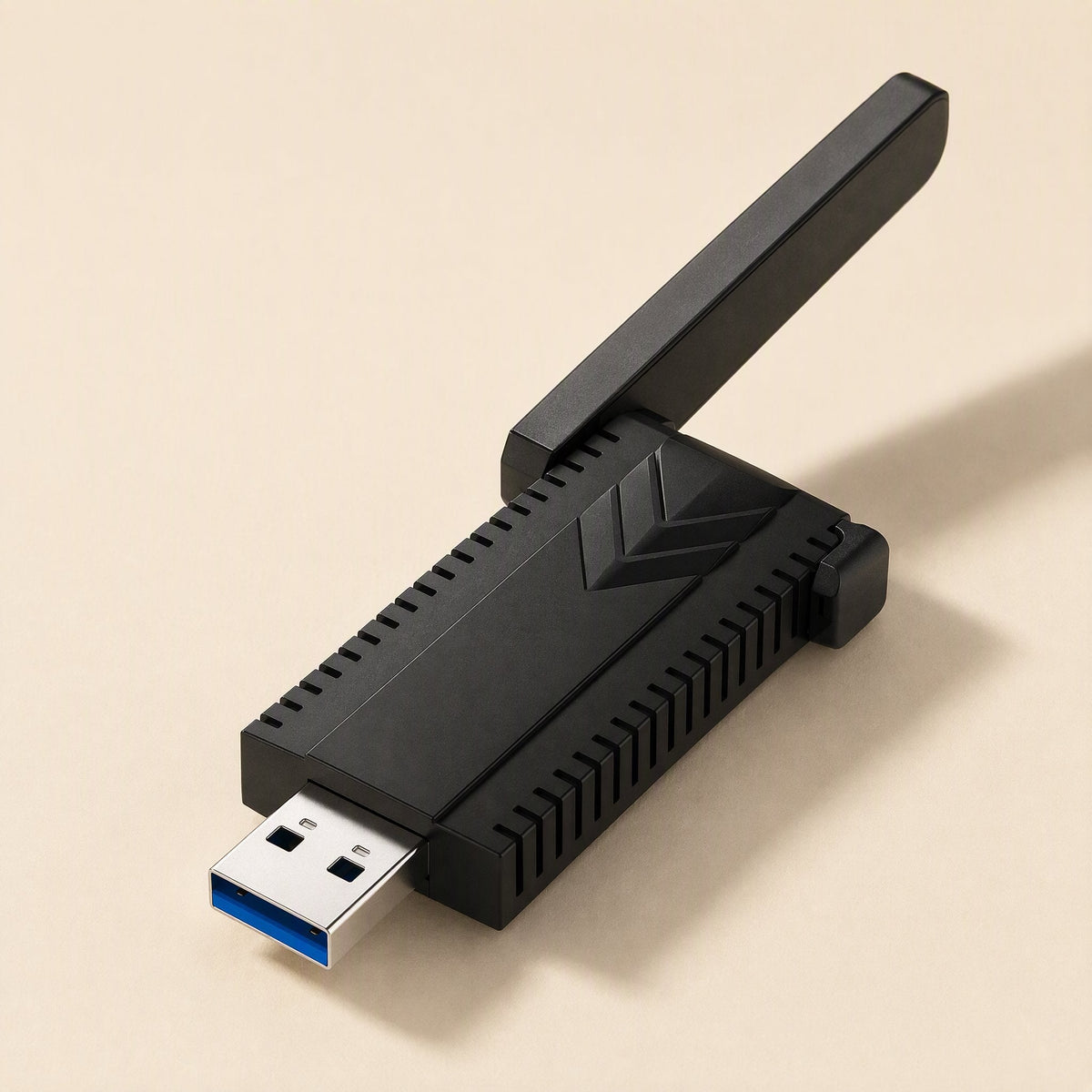 Bandreach – Top-angle view of the black USB adapter with one antenna tilted up and the blue USB connector in front