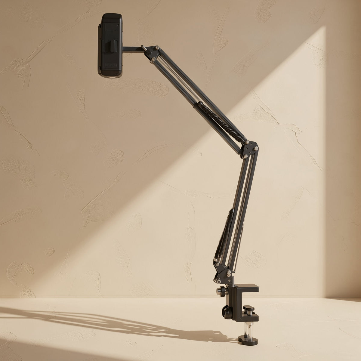 Clampmate – Tall black cantilever arm clamped to a table edge, raising a phone holder high above the base, side view