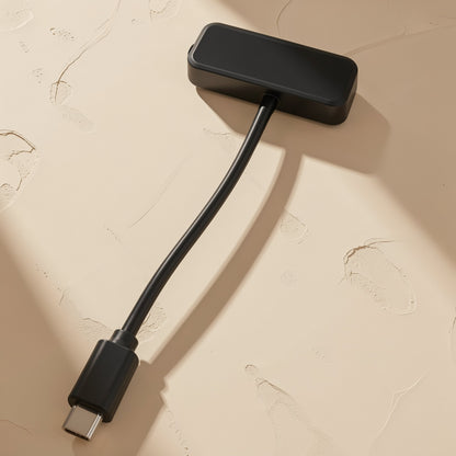 Portread – Black card reader lying flat with its flat back panel up and the Type-C plug at the end of the cable