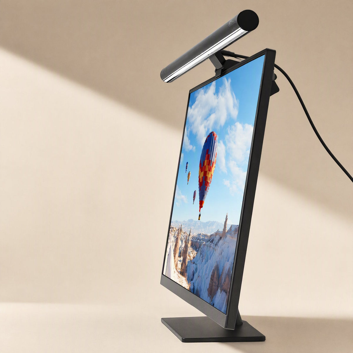 Glowhang Computer Screen Hanging Lamp mounted on top of a monitor showing a hot air balloon wallpaper