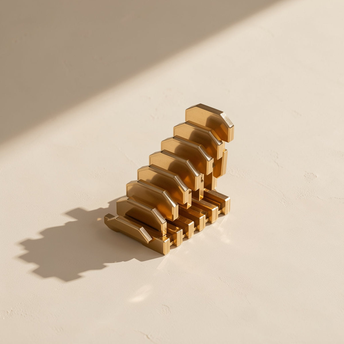 Netjoin – Close-up of stacked gold-plated contact pins from the RJ45 connector on a cream surface with soft shadow