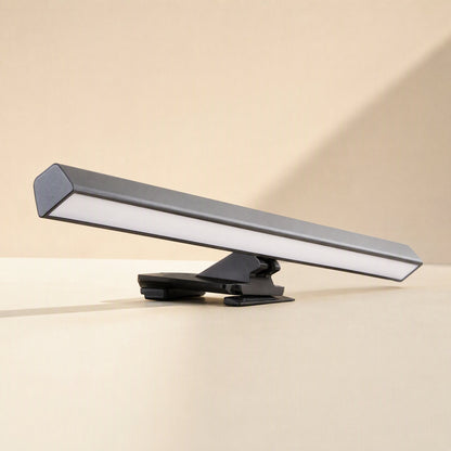 Offsetbeam – Black light bar with clip mount resting on a beige surface, shown from a low side angle