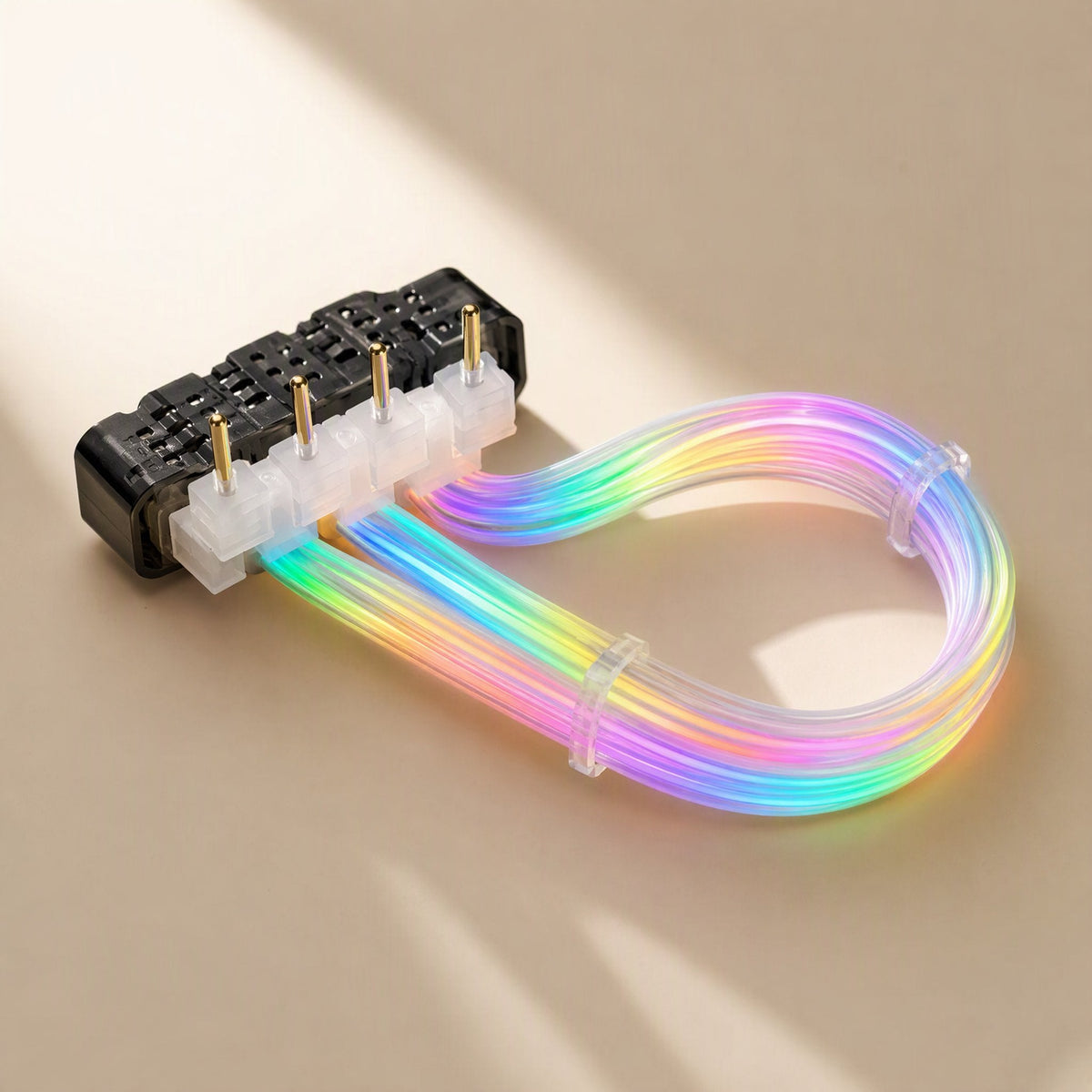 Glowgrid – Rainbow-lit cable looped from a black connector block with four gold pins, held by clear clips