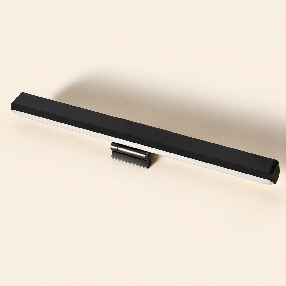 Metalshade Metal Monitor Hanging Lamp – black straight light bar with hinged clip mount, angled view against a cream backdrop