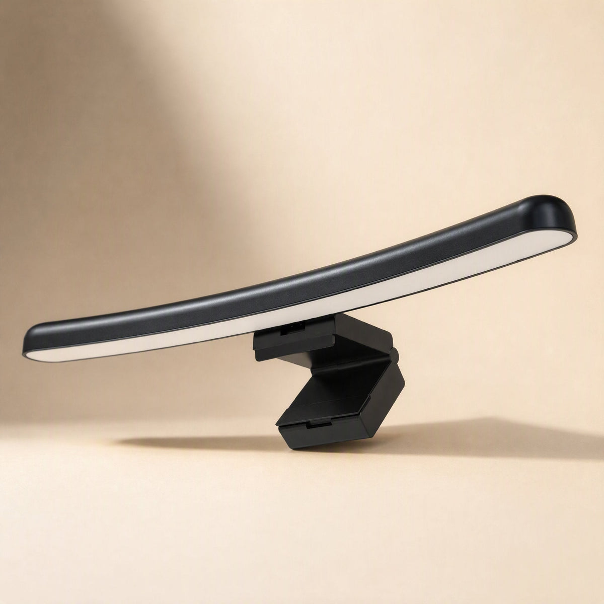 Metalshade – Curved black light bar on its clip, seen from a low angle with the glowing strip along the underside