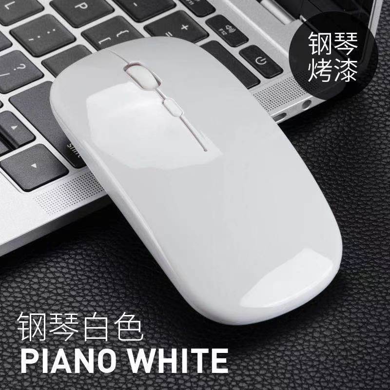 Silentclick Wireless Silent Computer Mouse – glossy piano white wireless mouse resting on a laptop keyboard