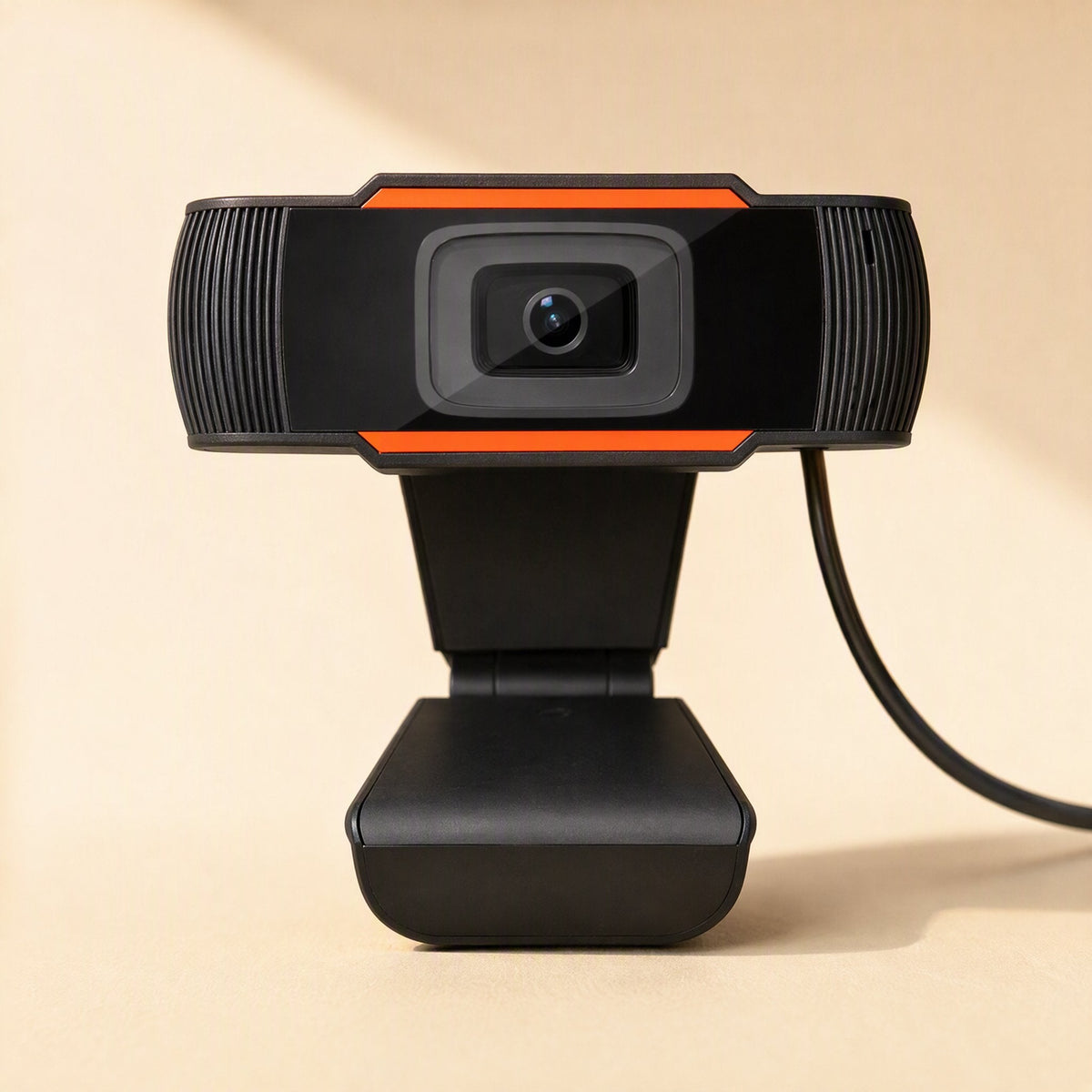 Voicelens USB Computer Camera webcam, front view with orange accents on a warm beige background