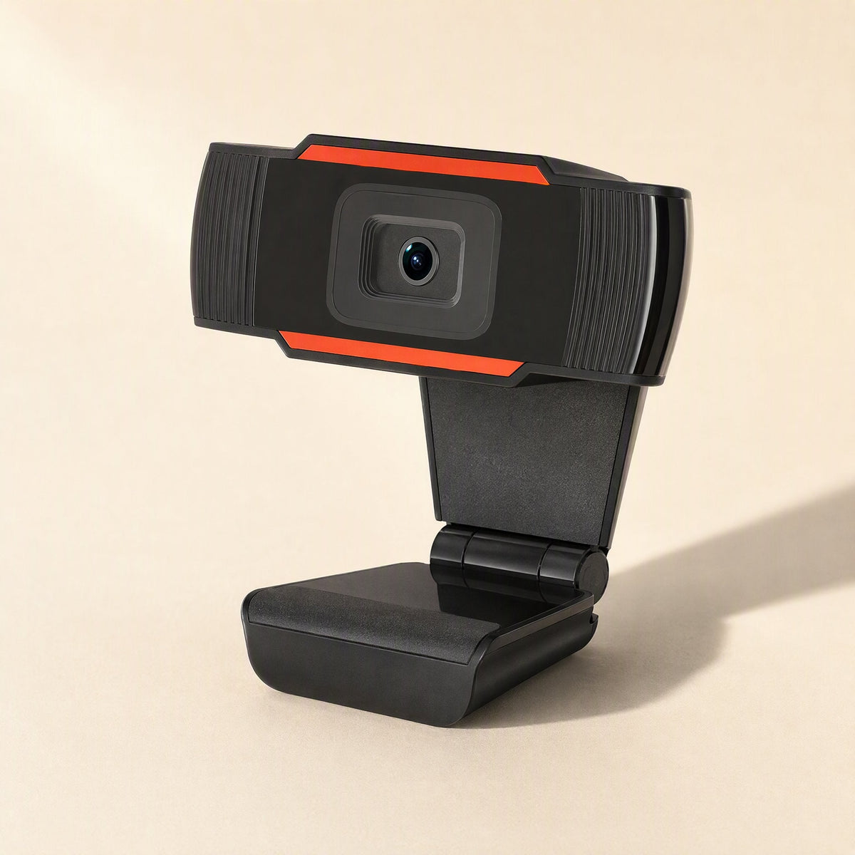 Voicelens – Webcam in three-quarter view showing the angled clip base and hinge, orange trim, soft shadow on the right