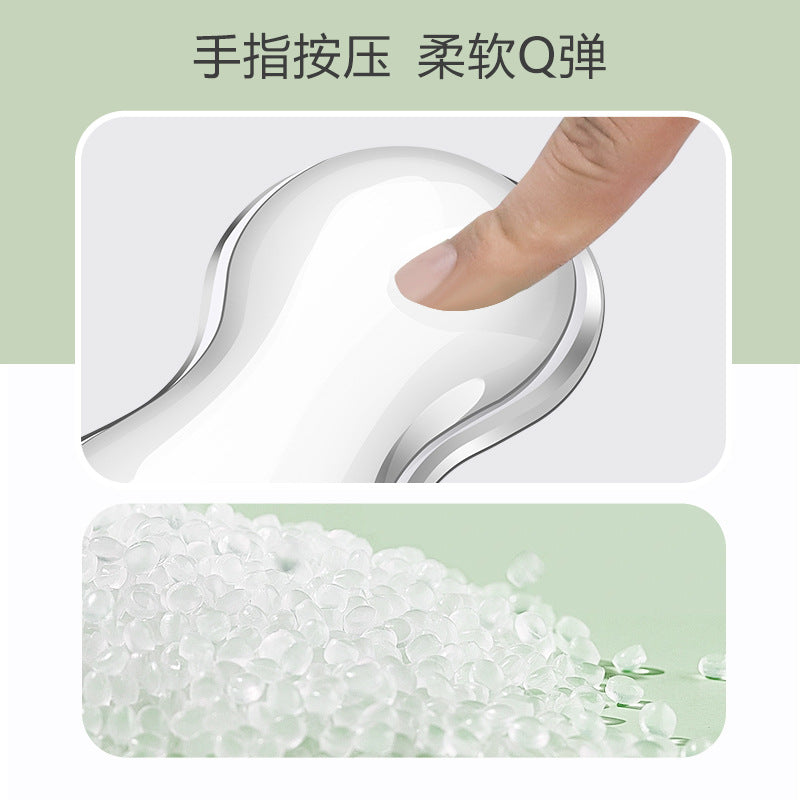 Cushkey – Fingertip pressing the soft clear gel pad, with a pile of translucent silicone beads below
