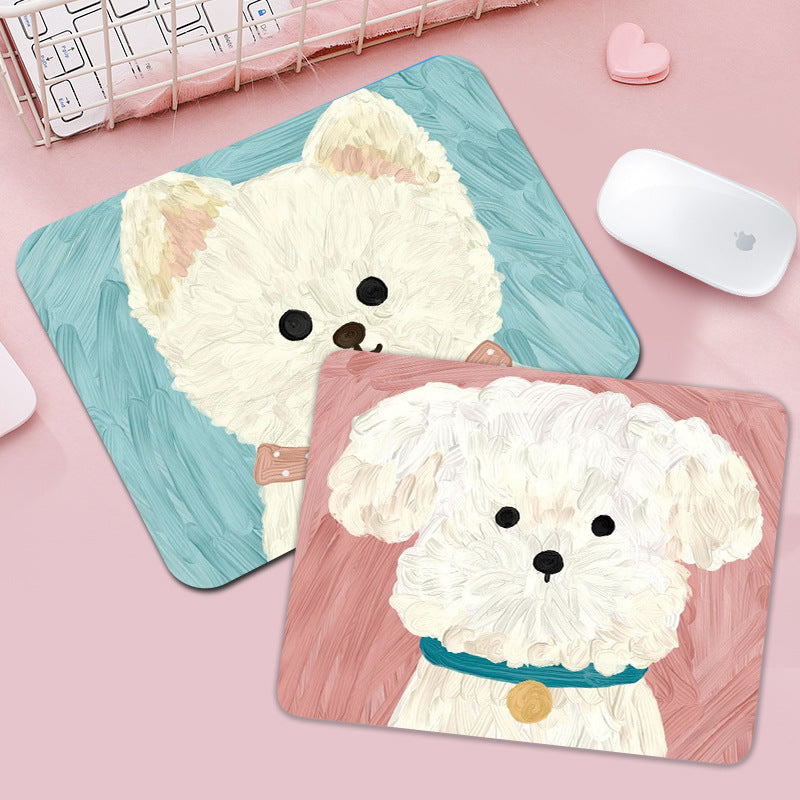 Pupmat – Two painted puppy mouse pads, one white dog on teal and one on pink, next to a white computer mouse