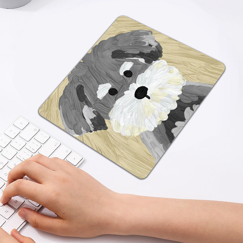 Pupmat – Square mouse pad with a gray schnauzer on a yellow background, a hand typing on a white keyboard nearby