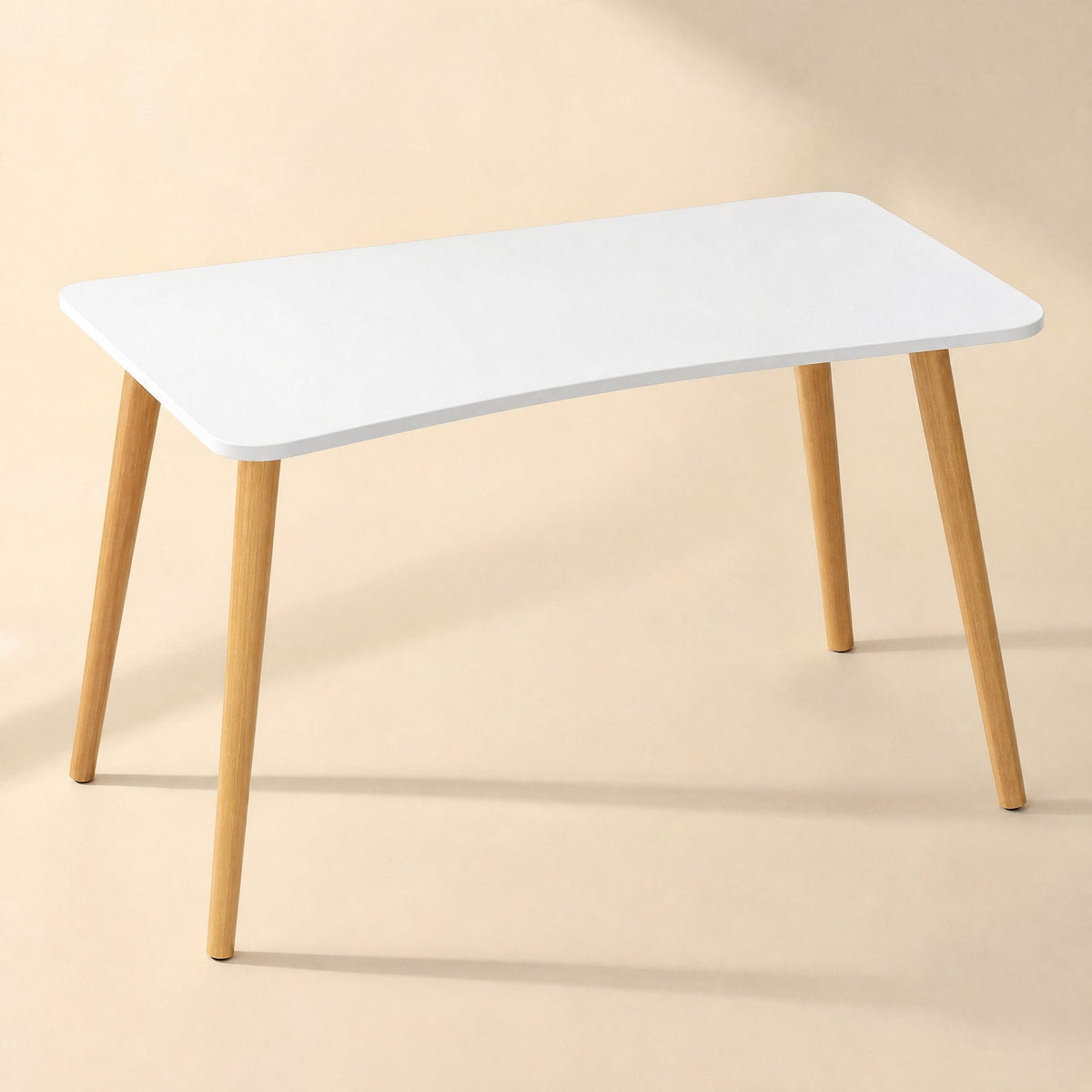 Workplane – Desk with white top and slim wooden legs seen from a slightly higher angle against a beige backdrop