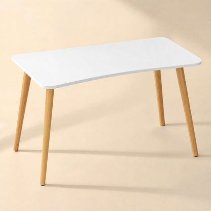 Workplane – Desk with white top and slim wooden legs seen from a slightly higher angle against a beige backdrop
