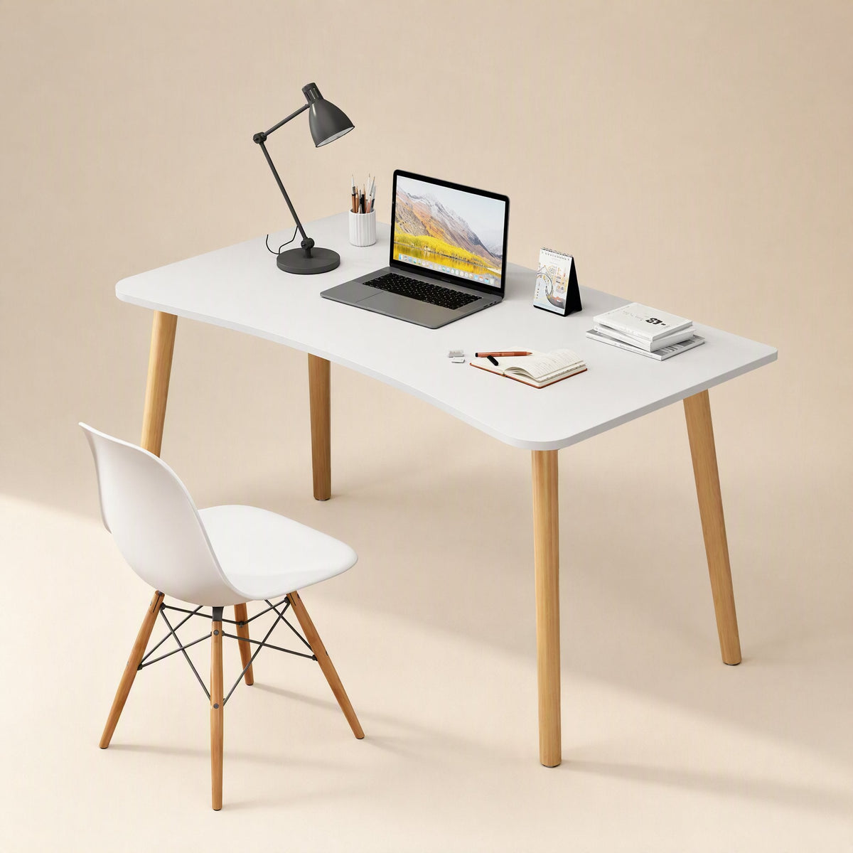 Workplane – White desk styled with a laptop, black desk lamp, books and a white chair with wooden legs