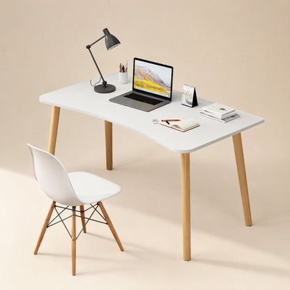Workplane – White desk styled with a laptop, black desk lamp, books and a white chair with wooden legs